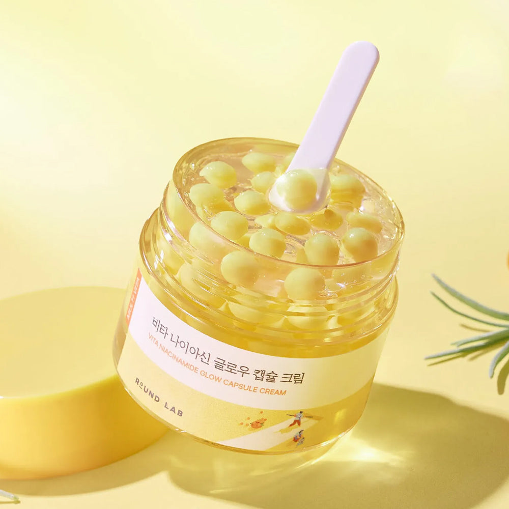 ROUND LAB Vita Niacinamide Glow Capsule Cream a lightweight Korean vitamin-enriched gel-cream moisturizer designed to brighten dull skin and provide deep hydration for a "glass skin" finish. It features unique moisturizing capsules suspended in a refreshing gel base that melt upon contact with the skin.