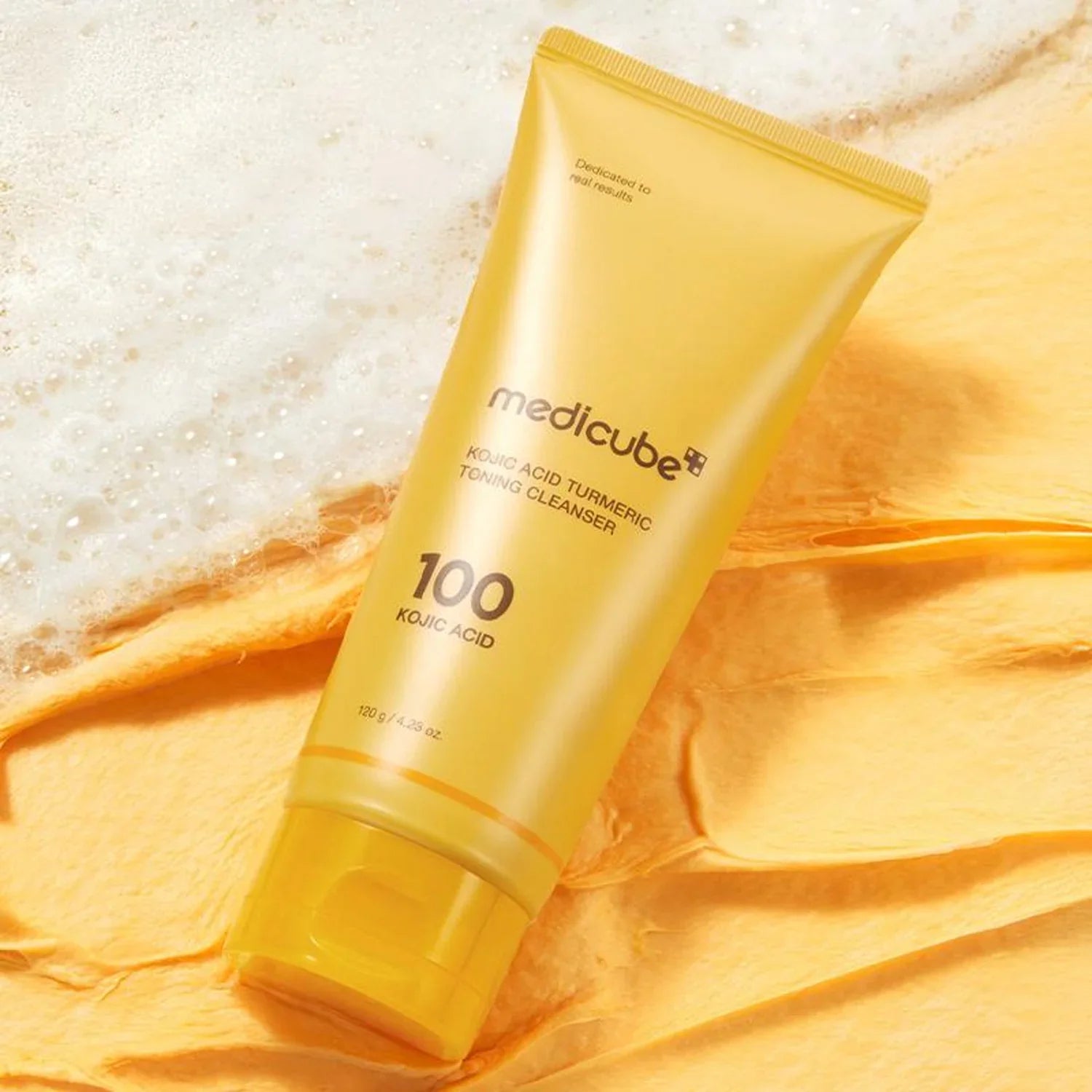 Yellow tube of Medicube cleanser on a yellow fabric background medicube Kojic Acid Turmeric Toning Cleanser asian authentic genuine original korean skincare montreal toronto calgary canada thekshop thekshop.ca natural organic vegan cruelty-free cosmetics kbeauty vancouver free shipping clean beauty routine skin makeup kpop stayz stan fandom photocard stray kids treasure ateez atiny dix30 brossard ddo royal mount st-bruno new store